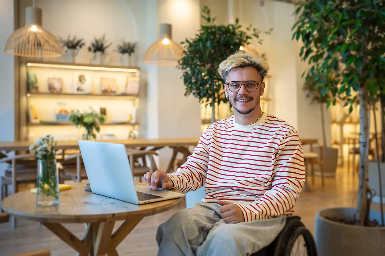A disabled man sitting in his wheelchair while smiling